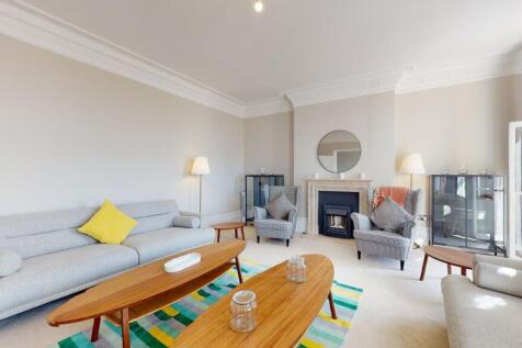 A bright and inviting living room featuring ele...