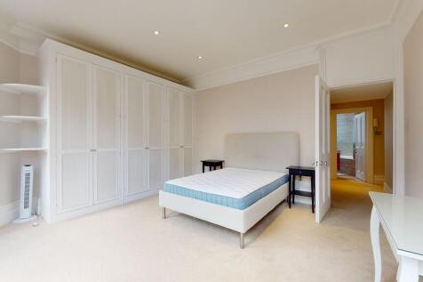 Bright and spacious bedroom featuring a large d...