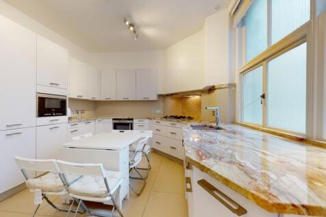 Bright and modern kitchen featuring sleek white...