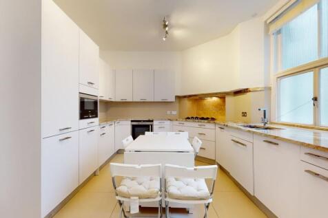 Bright and modern kitchen featuring sleek white...
