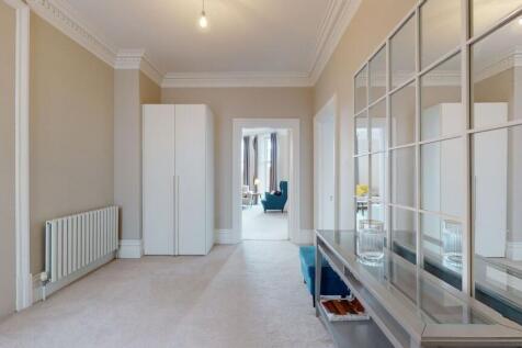 A spacious and well-maintained hallway featurin...