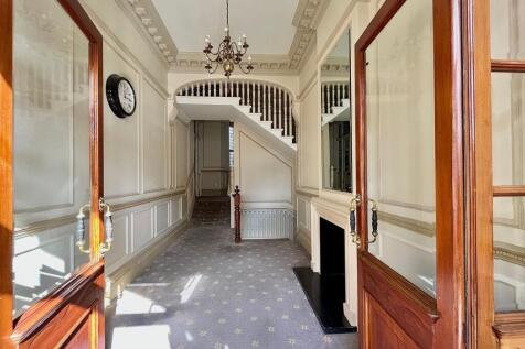 Bright and elegant hallway featuring classic de...