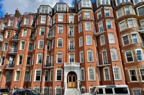 A striking red-brick terraced house with elegan...
