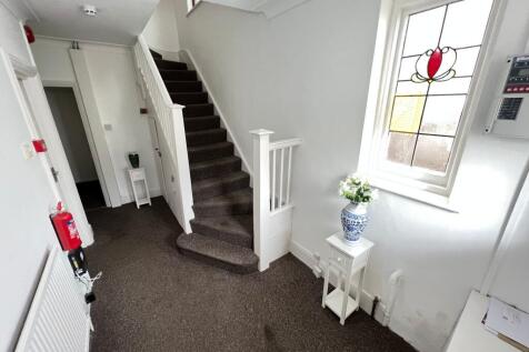 Bright hallway featuring a decorative stained g...