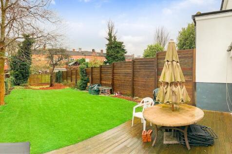 A spacious and well-maintained garden with a lu...