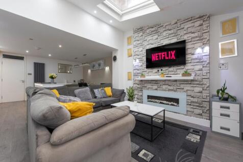 A modern and spacious living room featuring a l...
