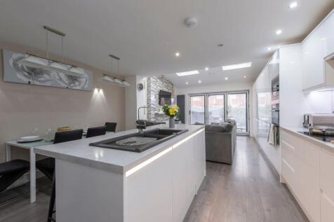 A sleek, modern open-plan living area featuring...