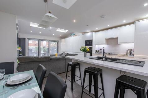 A modern open-plan living room and kitchen feat...