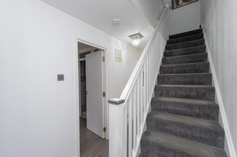 Bright and clean hallway featuring a modern sta...