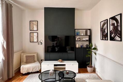 A stylish and contemporary living room featurin...