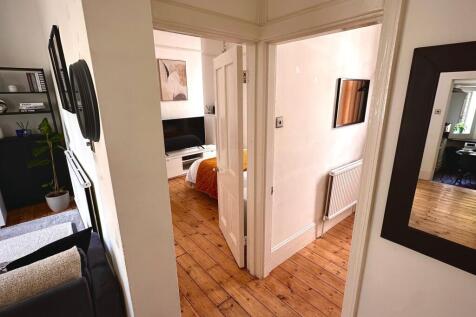 A neat and well-maintained hallway leading to a...