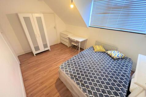 Bright double bedroom featuring a cozy double b...