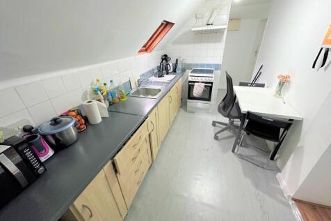A neat and functional kitchen featuring a long ...