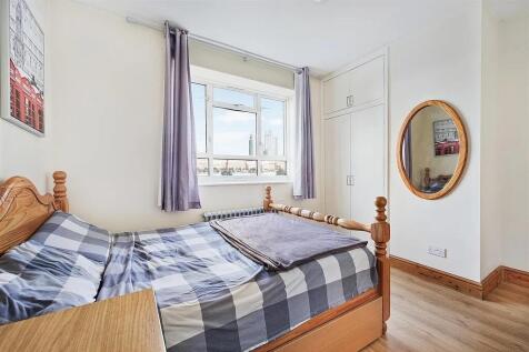 Bright and airy double bedroom featuring a larg...