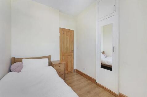 A neat and bright single bedroom featuring ligh...