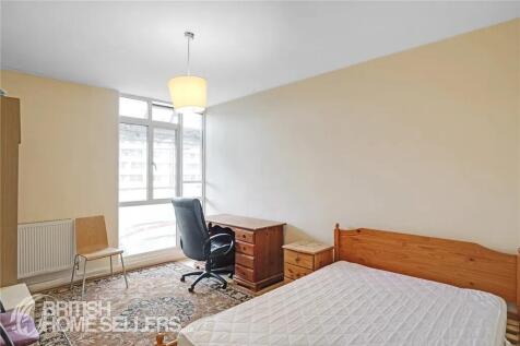 Bright and tidy bedroom featuring a wooden sing...