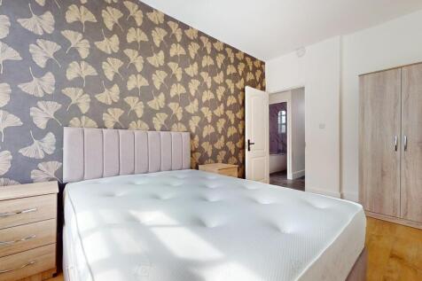 Bright double bedroom featuring a comfortable u...