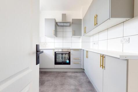 Bright and modern kitchen featuring sleek grey ...