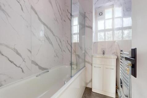 A sleek and modern bathroom suite featuring a s...