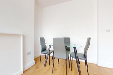 A modern living room featuring a sleek glass di...