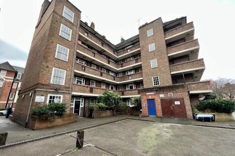 A well-maintained brick residential building fe...