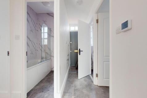 Bright and clean hallway featuring white walls ...