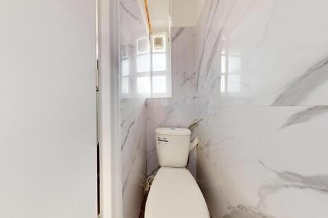 A clean and modern single toilet space featurin...