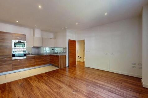 A modern open-plan living room with warm wood f...