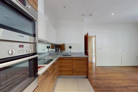 Modern kitchen with sleek wooden cabinetry, bui...