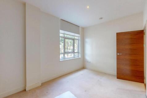 A bright and clean single bedroom featuring a l...