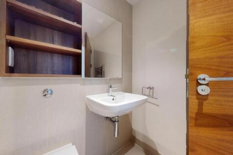 A modern and tidy bathroom featuring a sleek wa...