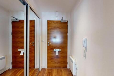 A clean and modern hallway featuring wood lamin...