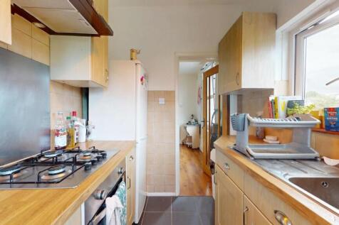 Bright and tidy kitchen featuring wooden counte...