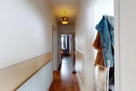A clean and well-maintained hallway with wooden...