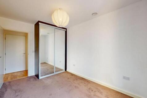 A bright and clean single bedroom featuring a l...