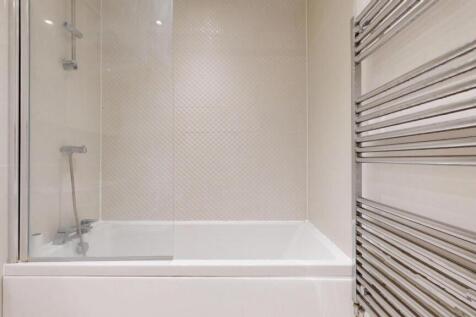 A modern bathroom suite featuring a clean white...