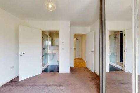 A clean and bright double bedroom featuring a m...