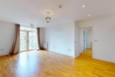 Bright and spacious living room featuring large...