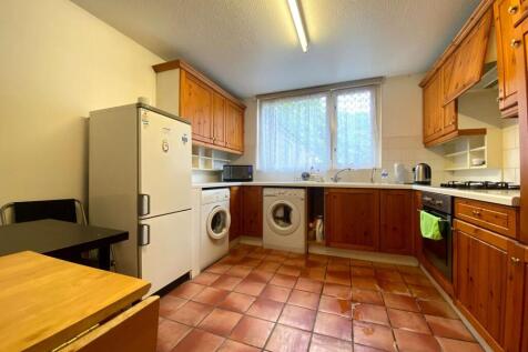 Bright kitchen featuring terracotta tiled floor...