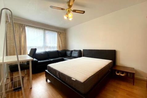 A bright and inviting master bedroom featuring ...