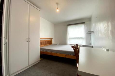 A simple and tidy double bedroom featuring a wo...