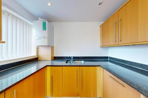 Bright and modern kitchen with ample countertop...