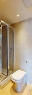 A clean and modern bathroom featuring a compact...