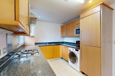 Modern kitchen with wooden cabinets, a stainles...