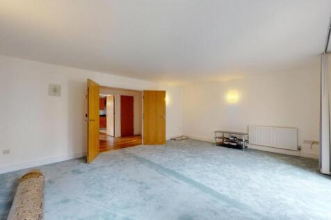 Bright and spacious living room with ample natu...