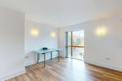 A spacious, bright living room with large windo...