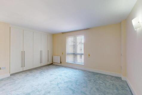 Bright and airy living room featuring a large w...