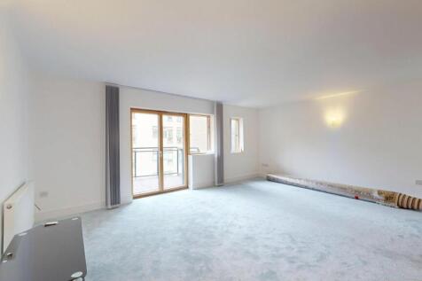 Bright and spacious living room with large wind...