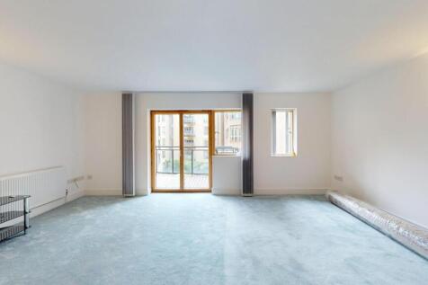 Bright and spacious living room with large wind...