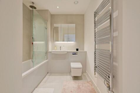 Modern, well-maintained bathroom featuring a sl...
